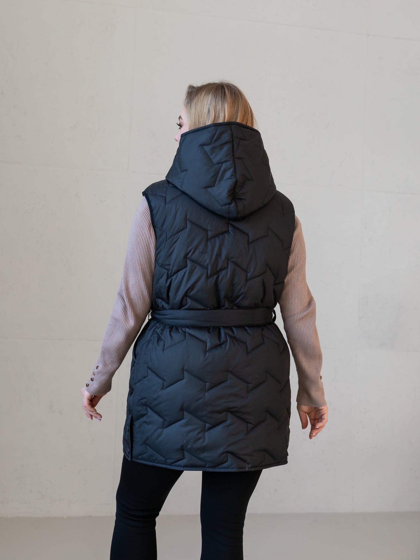 Moderne Damenweste mit Kapuze und femininer Silhouette.